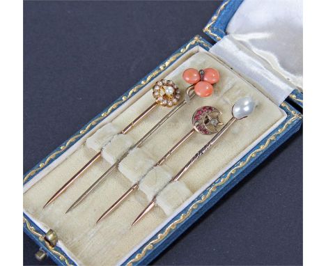 Four cased stick pins, to include a pearl example, a crescent moon example, a coral example and another pearl set example, ho