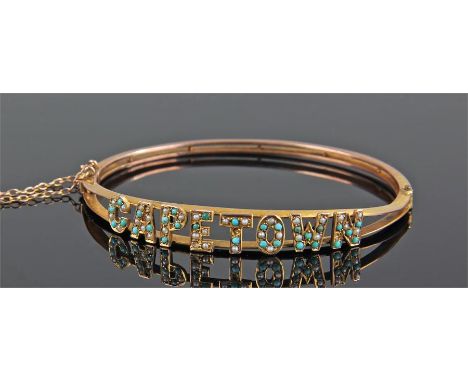 9 carat gold Capetown bangle, the letters set with turquoise and pearl, 6.5cm wide, 9.7 grams