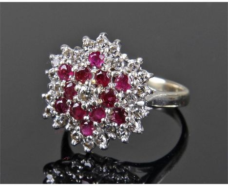 18 carat gold white gold, diamond and ruby set ring, flower head design with twenty six diamonds and thirteen rubies, ring si