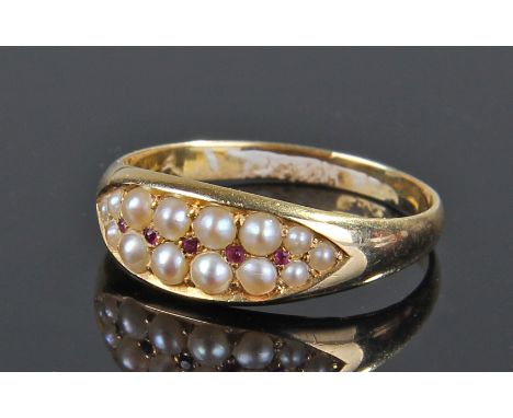 18 carat gold pearl and ruby set ring, with two rows of pearls and central row of rubies, ring size O