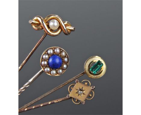 Four stick pins, to include a 15 carat gold pearl example, a green stone example and two Victorian examples, (4)