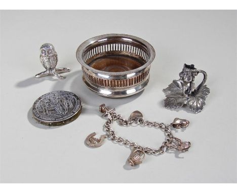 Mixed silver and plated wares, to include a silver charm bracelet, a silver plated coaster and silver plated pin cushion, als