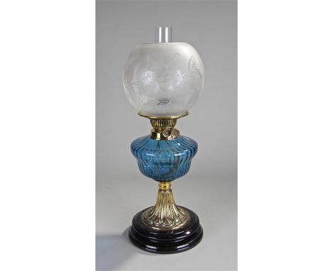 Victorian oil lamp, the etched shade above a blue glass font, and lappet brass foot, 58cm high