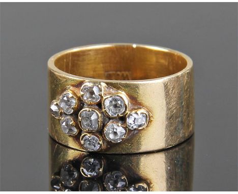 18 carat gold diamond set ring, the wide band set with nine old brilliant cut diamonds, ring size K
