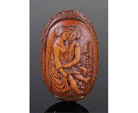 Early 19th Century erotic snuff box, carved with a scene to the lid of a man and lady seated, the reverse carved with a lady 