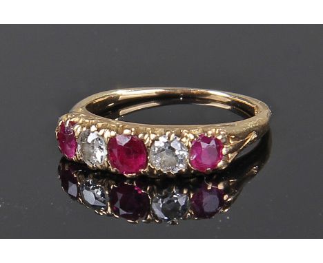 18 carat gold ruby and diamond set ring, with a central ruby flanked by a pair of diamonds and a further pair of rubies, ring