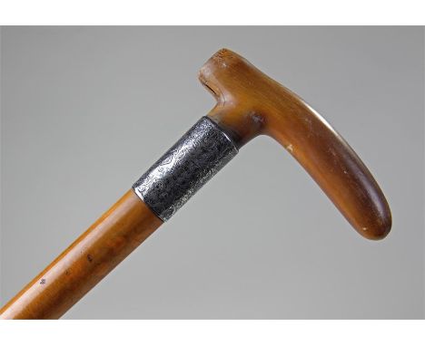 Circa 1905 Rhino horn handled walking stick, with silver collar assayed for London 1905, above a malacca cane, 89cm high