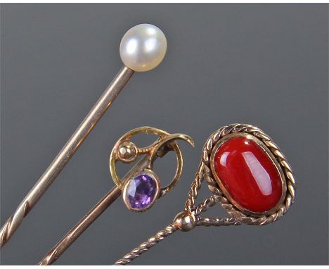 Four stick pins, to include an example with a pearl set to the top, a 15 carat gold amethyst set example and two further stic