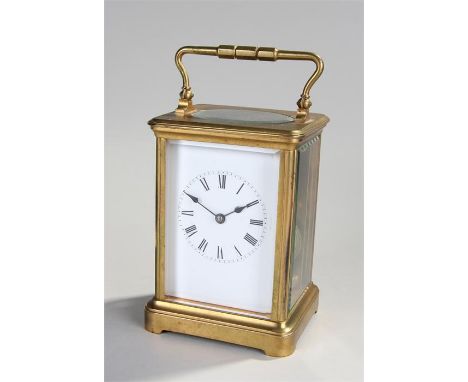 Early 20th Century French gilt brass carriage clock, the corniche case with five bevelled glass panels, white enamel dial wit