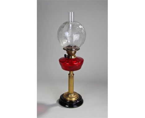 Victorian oil lamp, the etched shade above a cranberry glass font and reeded column, 65cm high