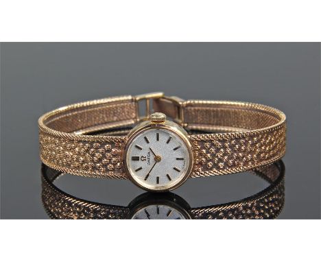 Omega ladies 9 carat gold wristwatch, the silvered dial with gilt baton hour makers, 9 carat gold case and strap, complete wi