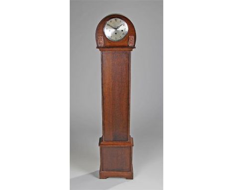 Early 20th Century oak longcase clock, of small proportions, the arched top above a long trunk and plinth base, circular silv