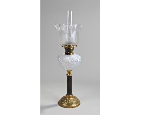 Victorian oil lamp, the etched shade above an Art Nouveau font, raised on a reeded ebony column and brass foot, 67cm high