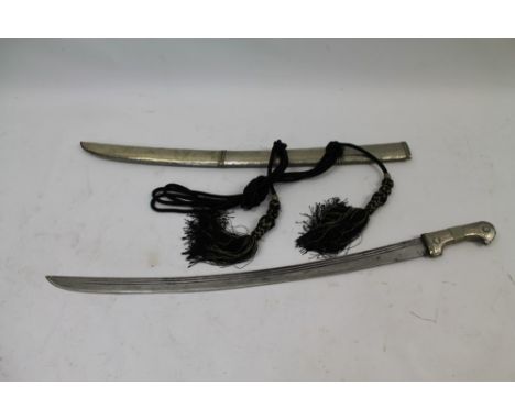 Eastern Shasqua sword with white metal and brass mounts with curved fullered blade in matching scabbard with fluted boss deco