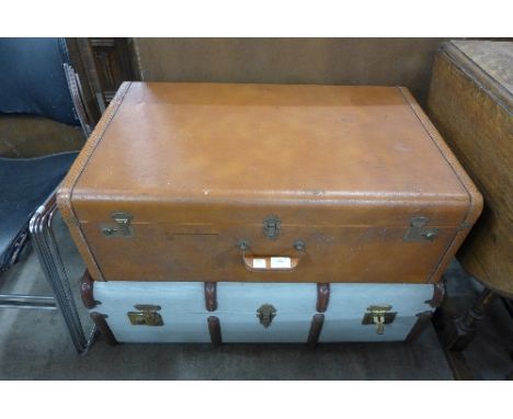 A banded travel trunk and a brown leather case