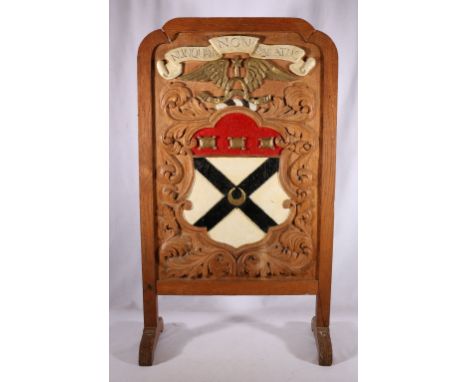 Oak framed firescreen with Clan Johnstone crest bearing the motto Nunquam non Paratus, 86cm tall 