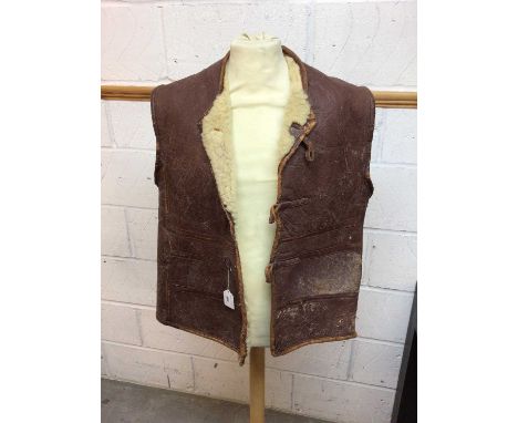Second World War period leather and sheepskin jerkin with button fasteners. No size indication but fits one of our staff who 