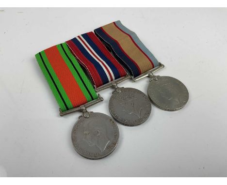 Second World War Australian medal trio comprising Defence and War medals together with Australia Service medal 1939 - 45, all