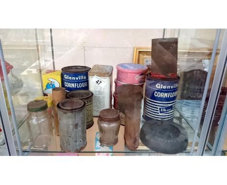 A shelf of advertising tins etc.