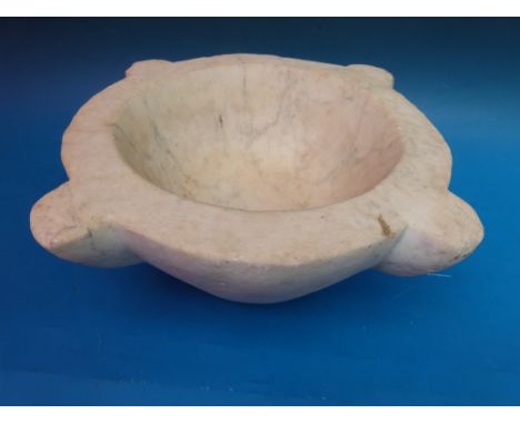 A large marble mortar with compass points