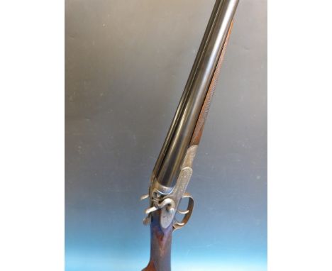 A Daniel Fraser 12 bore double barrelled side by side hammer action shotgun with all over scrolling engraving and dolphin ham