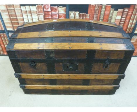 A 19thC metal and ash bound domed trunk with leather carrying handles (68cm long x 45cm wide)
