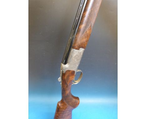 A Browning 525 Prestige 20 bore over and under shotgun with 3/4 1/2 and 1/4 removable chokes, choke removal tool and two repl