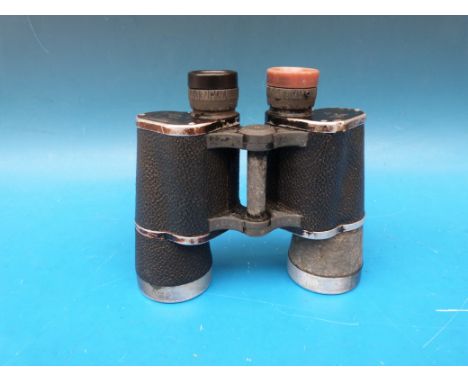 A pair of German Leitz binoculars marked beh KF and 10x50 374095 M H/6400 with further erased word above