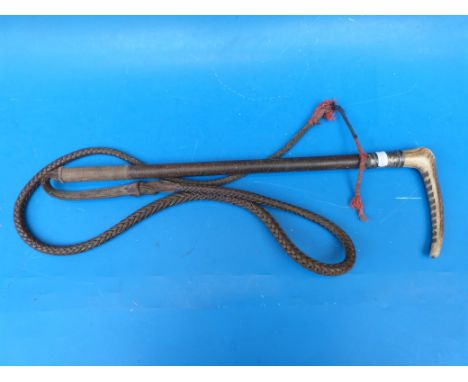 A Swaine and Adeney hunting crop with hallmarked silver collar and makers name on button to top, the shaft being woven leathe