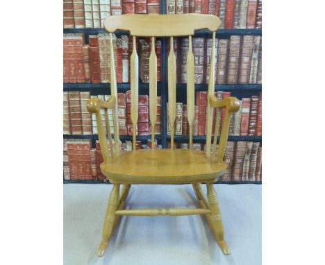 A beech rocking chair with stick back and turned legs