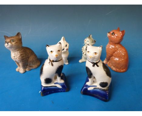 A collection of ceramic cats including Staffordshire, Beswick etc