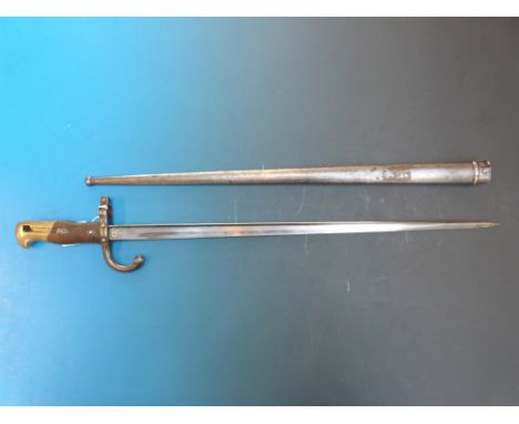 A French bayonet in scabbard with brass and wooden handle, the blade marked St Etienne 1878