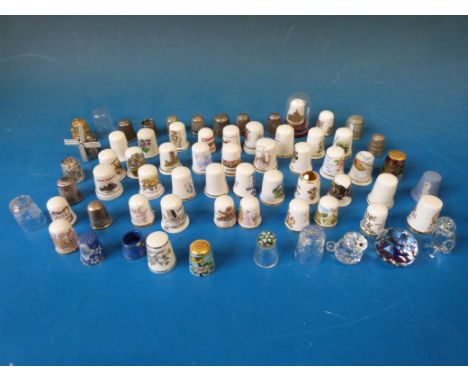A collection of ceramic, metal and glass thimbles to include three silver thimbles 