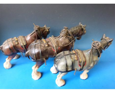 Four harnessed ceramic Shire horses and wooden cart