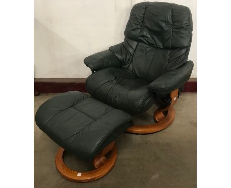 A Norwegian Ekornes green leather and beech Stressless revolving lounge chair and footstool 