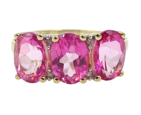 Gold three pink stone and diamond chip ring, stamped 9k - Condition Report Approx 2.9gm, size N-O