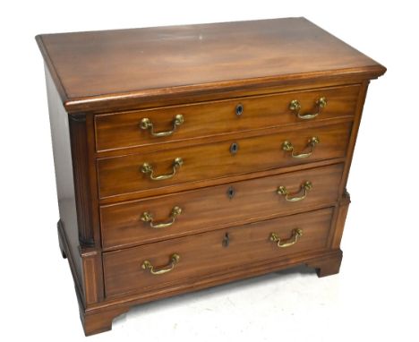 An early 19th century dressing chest of four drawers, the top drawer enclosing a fitted section with mirror, raised on bracke