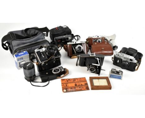 A group of cameras and accessories including a Zenit-B with Helios-44 2/58 lens, Zorki-4K camera with Jupiter-82/50 lens, Ado