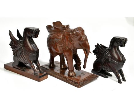 An Indian carved model of an elephant, raised on rectangular plinth base, height 32cm, length 38cm, together with a pair of c