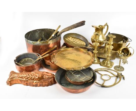 A quantity of copper and brass including pans, graduated small saucepans, chamber stick, etc.