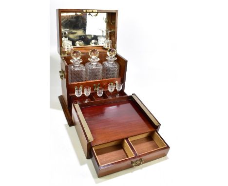 An Edwardian inlaid mahogany decanter box, the hinged cover enclosing mirrored panel and part fitted matched interior, to inc