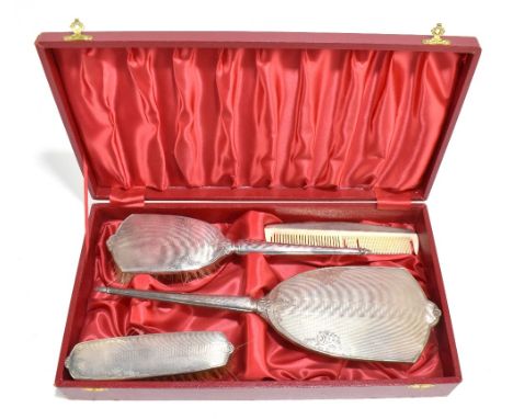 CHARLES S GREEN &amp; CO LTD; a cased Elizabeth II hallmarked silver mounted four piece dressing table set with engine turned