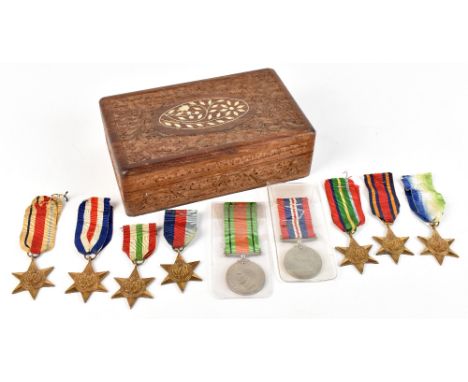 Nine WWII medals including the Defense medal, Burma Star, France and Germany Star, the Atalantic Star, the Africa Star, etc (