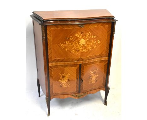 A reproduction kingwood veneered serpentine fronted cocktail cabinet, the pull-down door enclosing fitted mirrored interior a