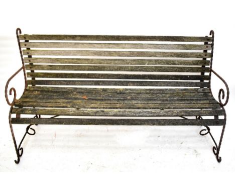 A wooden slatted three seater garden bench raised on wrythen twisted wrought iron end supports, length 154cm.Additional Infor