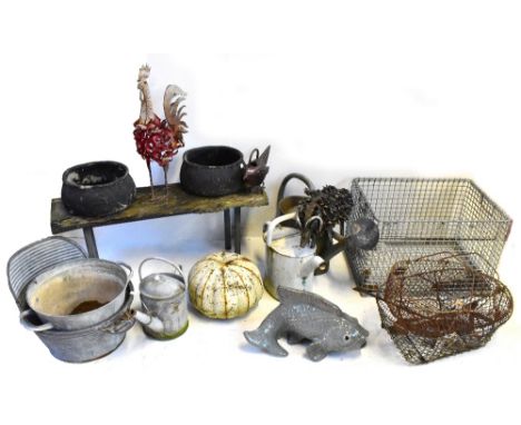 A large group of garden items including a low dolly tub, small bench, pair of fibreglass planters, a large cock, two baskets,