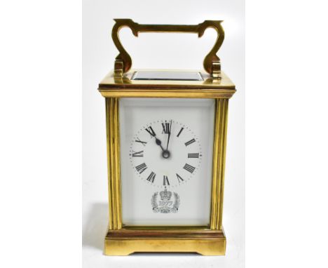 A brass cased carriage clock, the white enamelled dial set with Roman numerals above detail for the Queen's Silver Jubilee 19