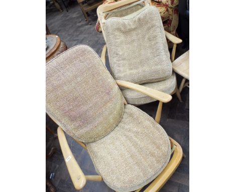 A pair of Ercol light elm fireside style chairs with stick backs and a matching stool, struts need attention