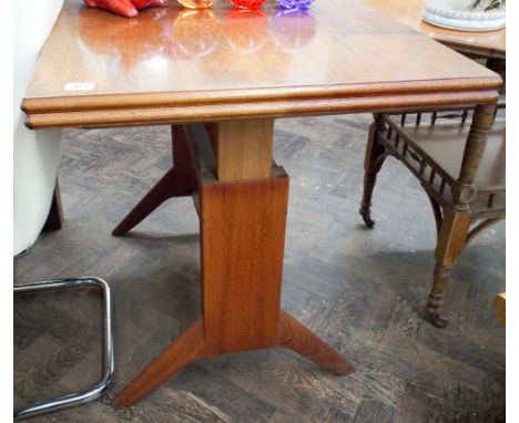 A 1970's fold over teak dining table on a stretcher style base 3'3 wide 