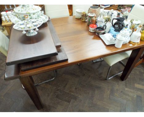 A large mahogany extending dining table with two leaves standing on square taper legs 